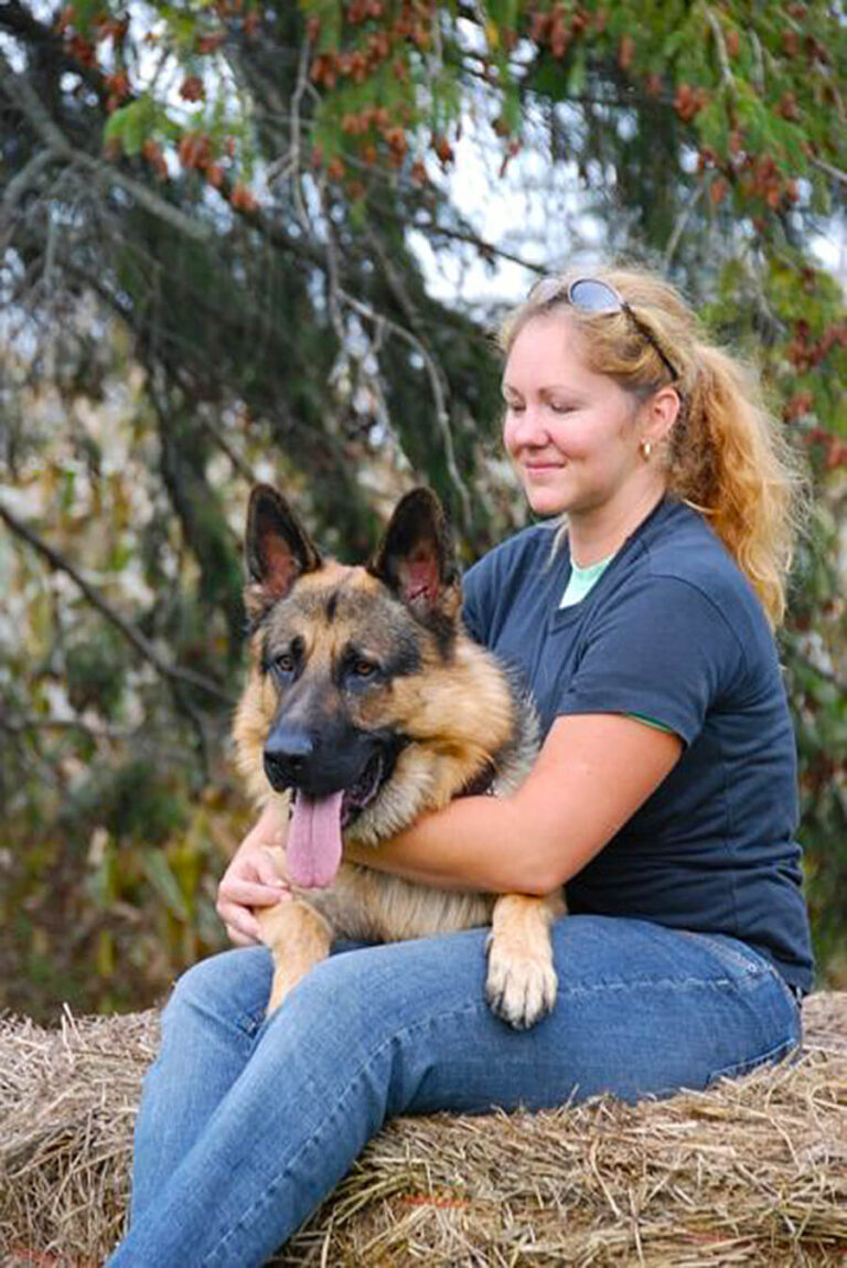 Woman sitting with her German Shepherd dog at TorontoK9Center.com