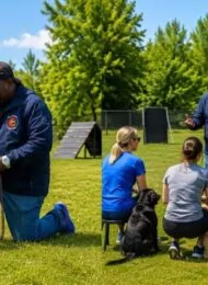 Board & Train vs weekly dog training lessons at Toronto K9 Center in Whitby showing Roger Richards working with a German Shepherd and leading a group dog training class.